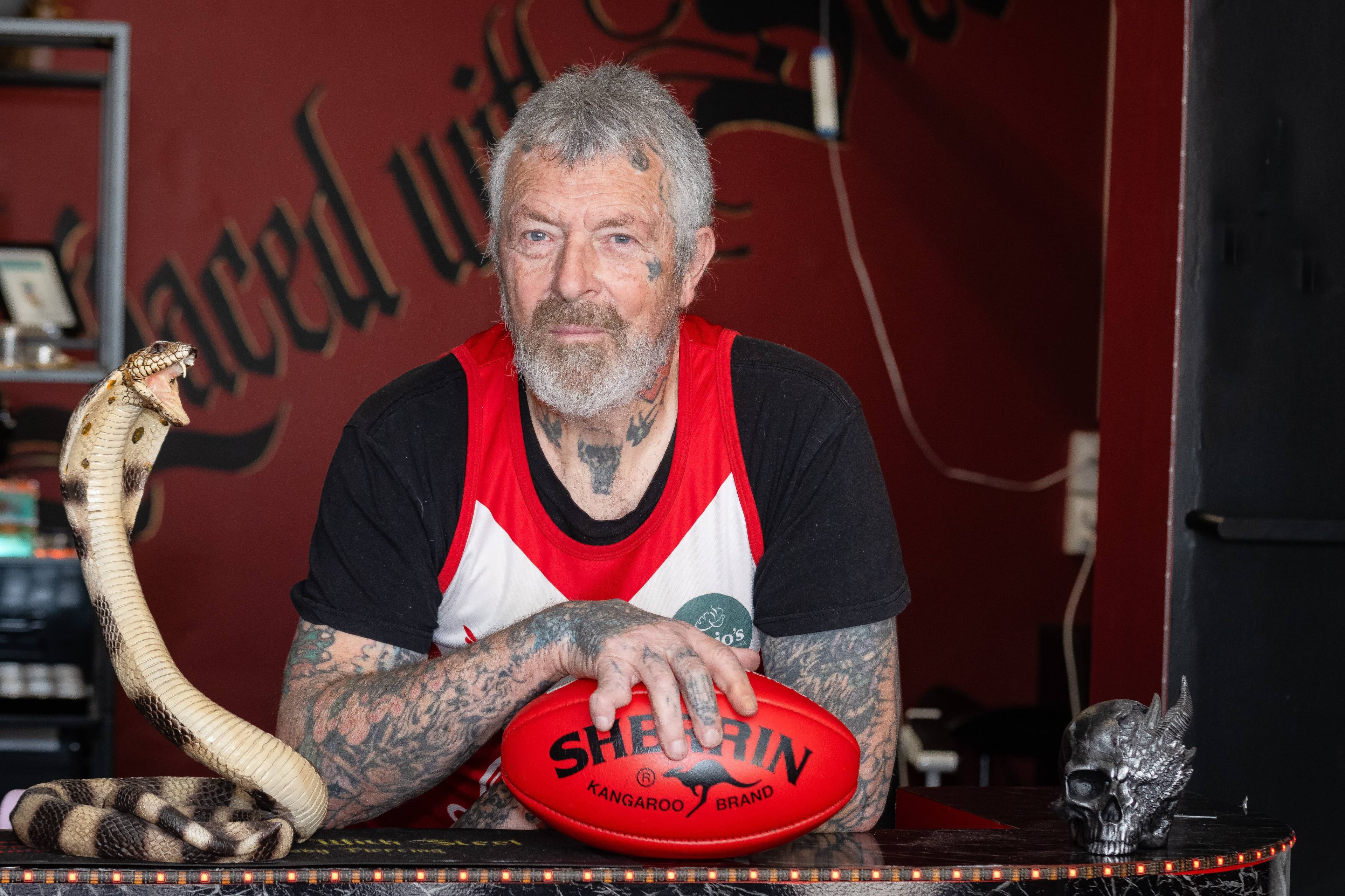At 69 years old, Ron Lidgerwood is the oldest active player in the NWFL. Pictured at his tatooing business in Devonport. Picture by David Bellamy 8 August 2025.