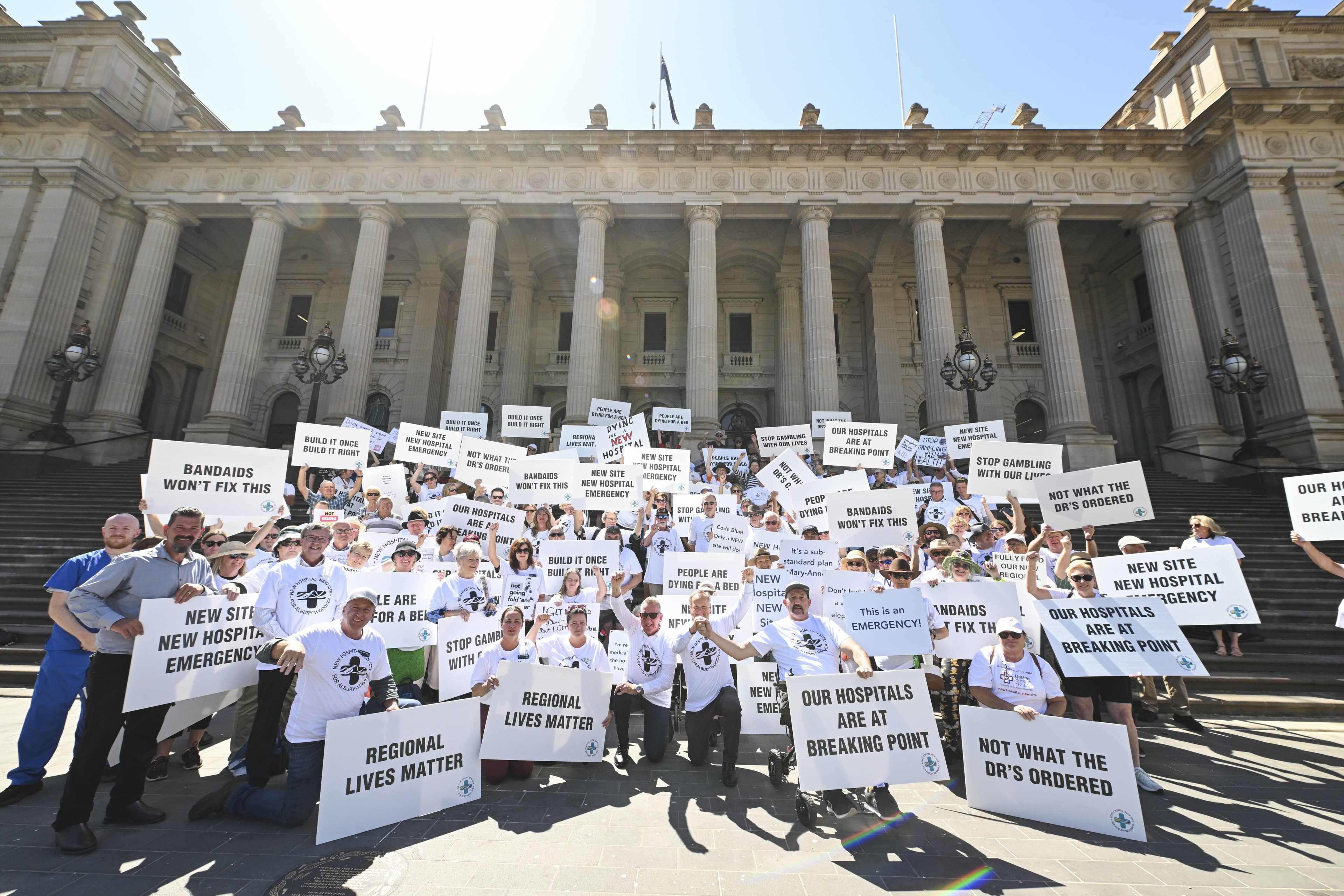 Members of the Albury and Wodoonga community rally on the steps of the Victorian Parliament in Melbourne, demanding the government built the community a greenfield hospital. Picture by Mark Jesser