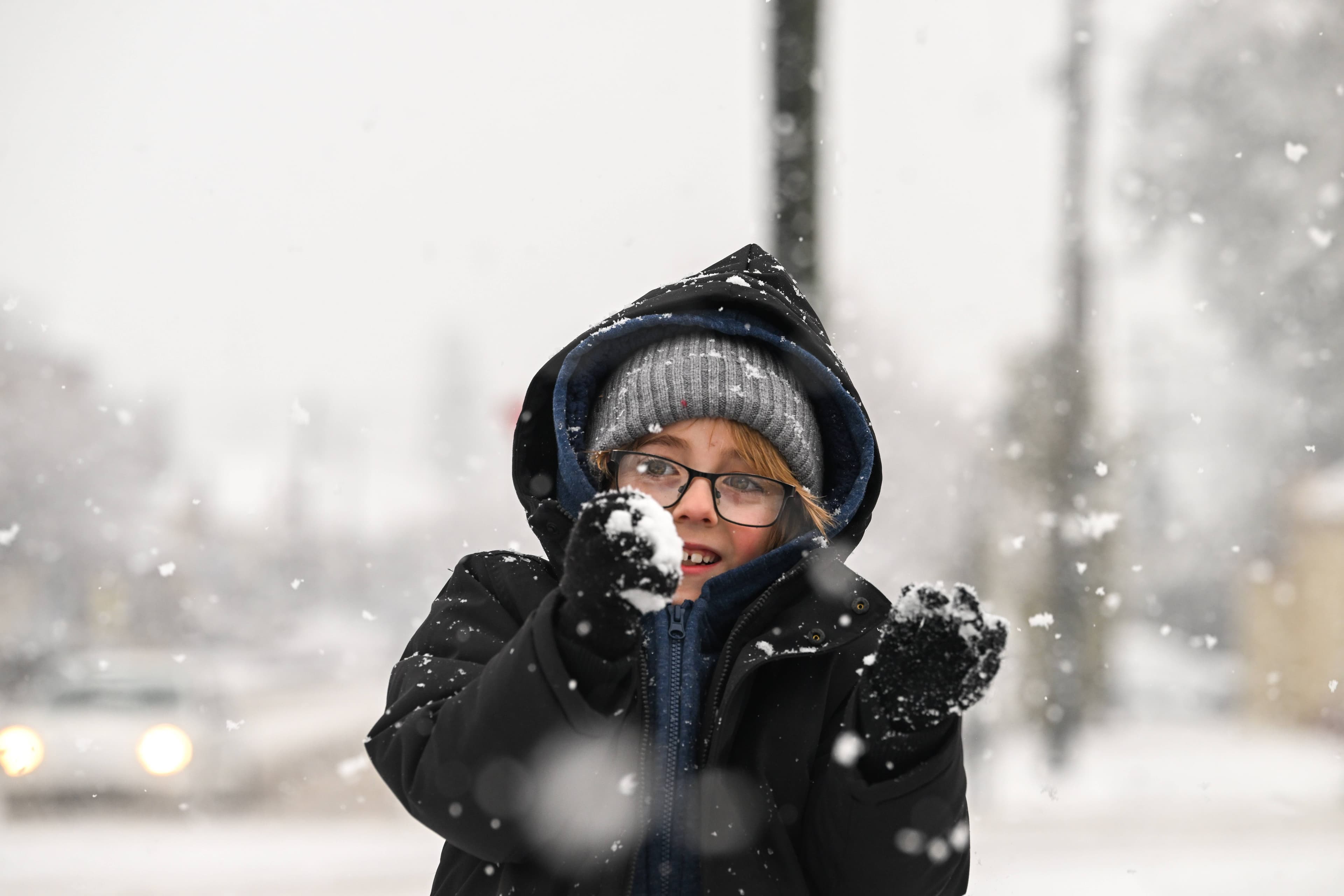 Asher Gardner rolls a snowball ahead of a snowstorm at Uralla located in the Northern Tablelands of NSW. Picture by Gareth Gardner