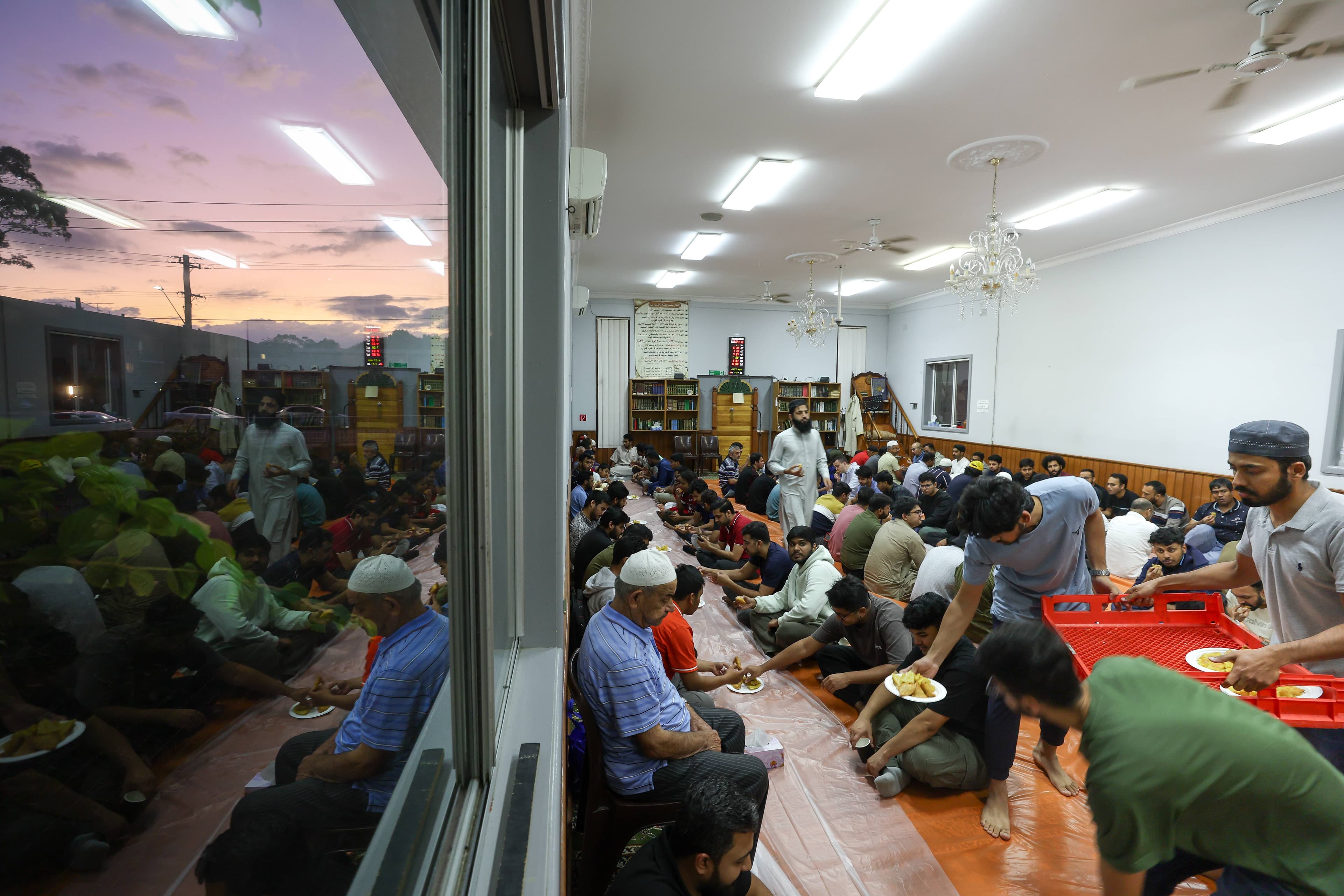 Dinner service for the 'breaking of the fast' at Omar Mosque during Ramadan. Photo shows men eating Photo: Adam McLean
