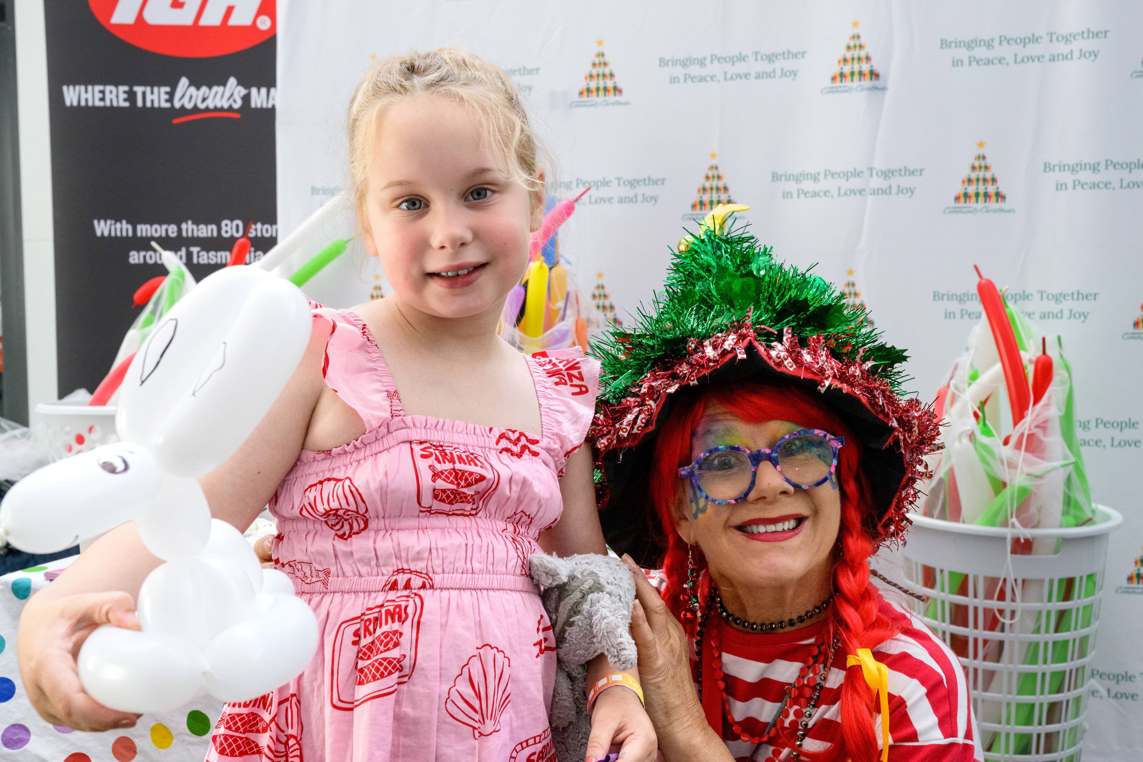 Christmas gnome Marcelle made a balloon animal for Izabella Doran. Picture by Phillip Biggs