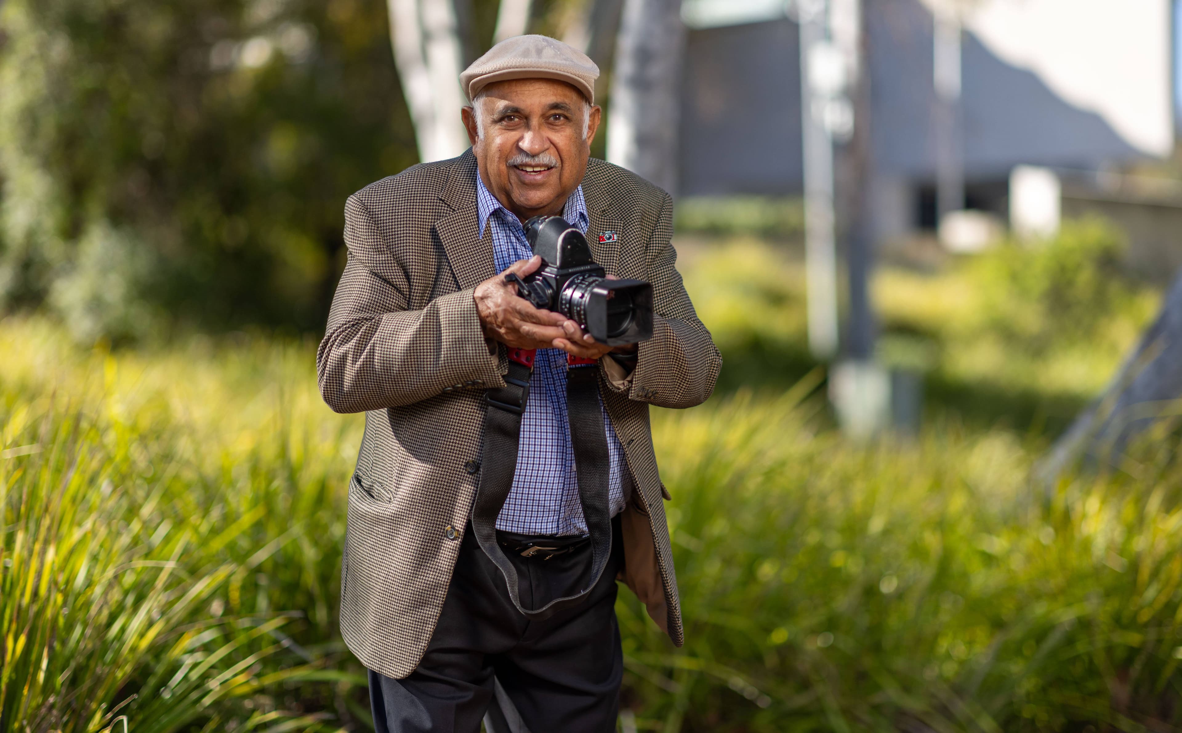 Mervyn Bishop with a Hasselblad camera, the type of camera he used to take his well-known image of Gough Whitlam and Vincent Lingiari. Picture by Gary Ramage