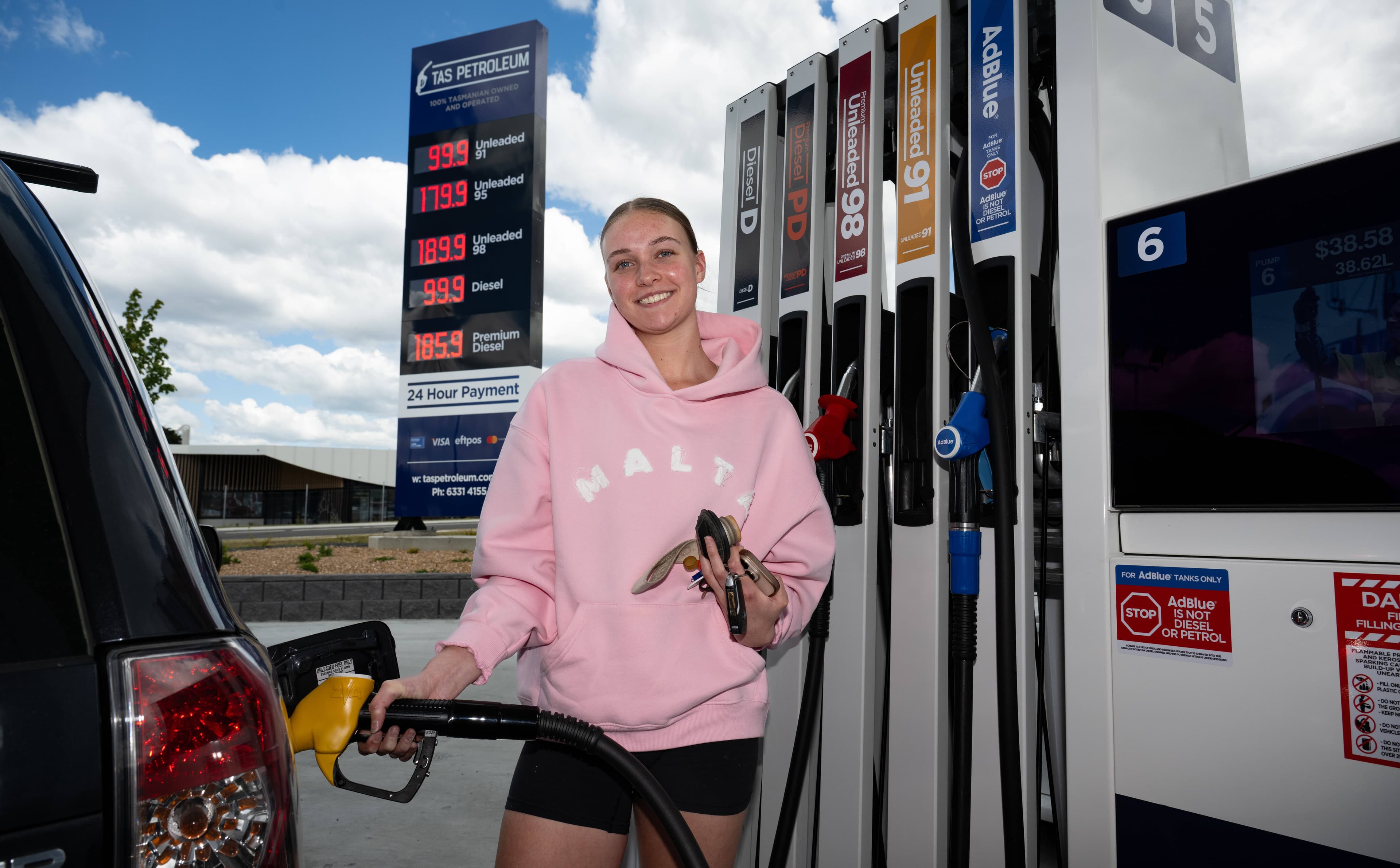 Grace Foley of Legana fills up with fuel on November 20 when Legana Tas Petroleum offered $0.99 cents per litre for petrol and diesel on its opening day