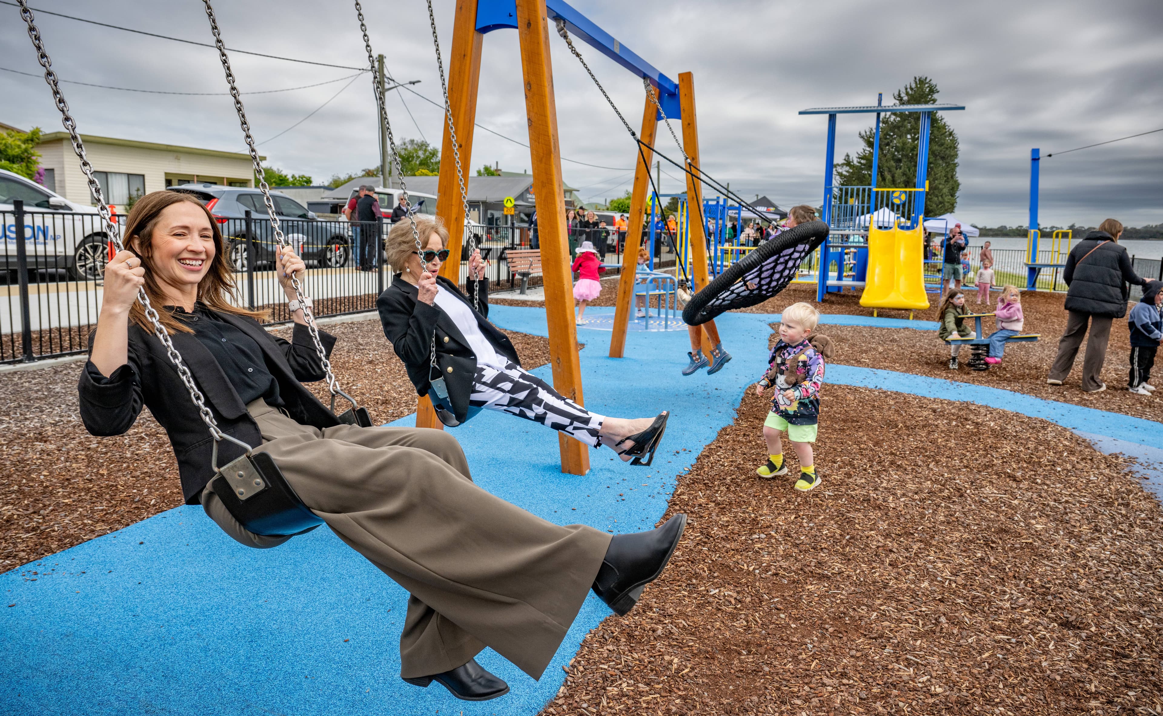 Bass Labor MP Jess Teesdale and West Tamar Mayor Christina Holmdah on the swings in the playground after the official opening of the Beauty Point Foreshore Redevelopment in November.
