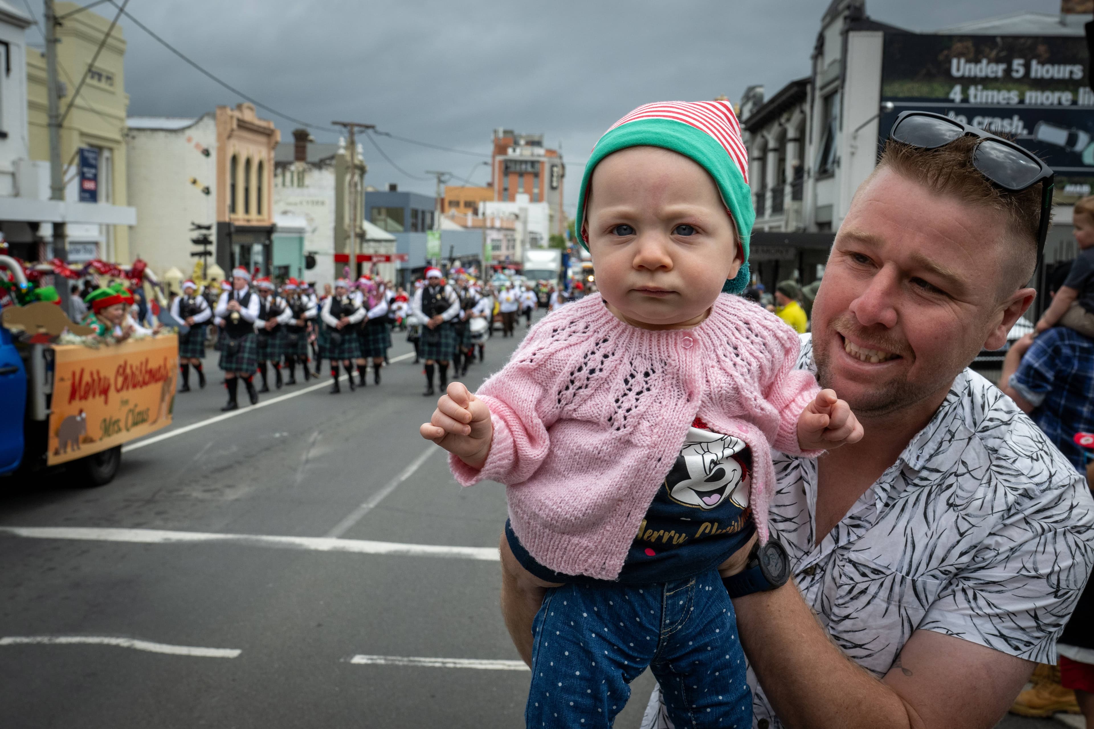 Roger Brown and daughter Grace of Launceston watch the City of Launceston Christmas Parade on December 6.