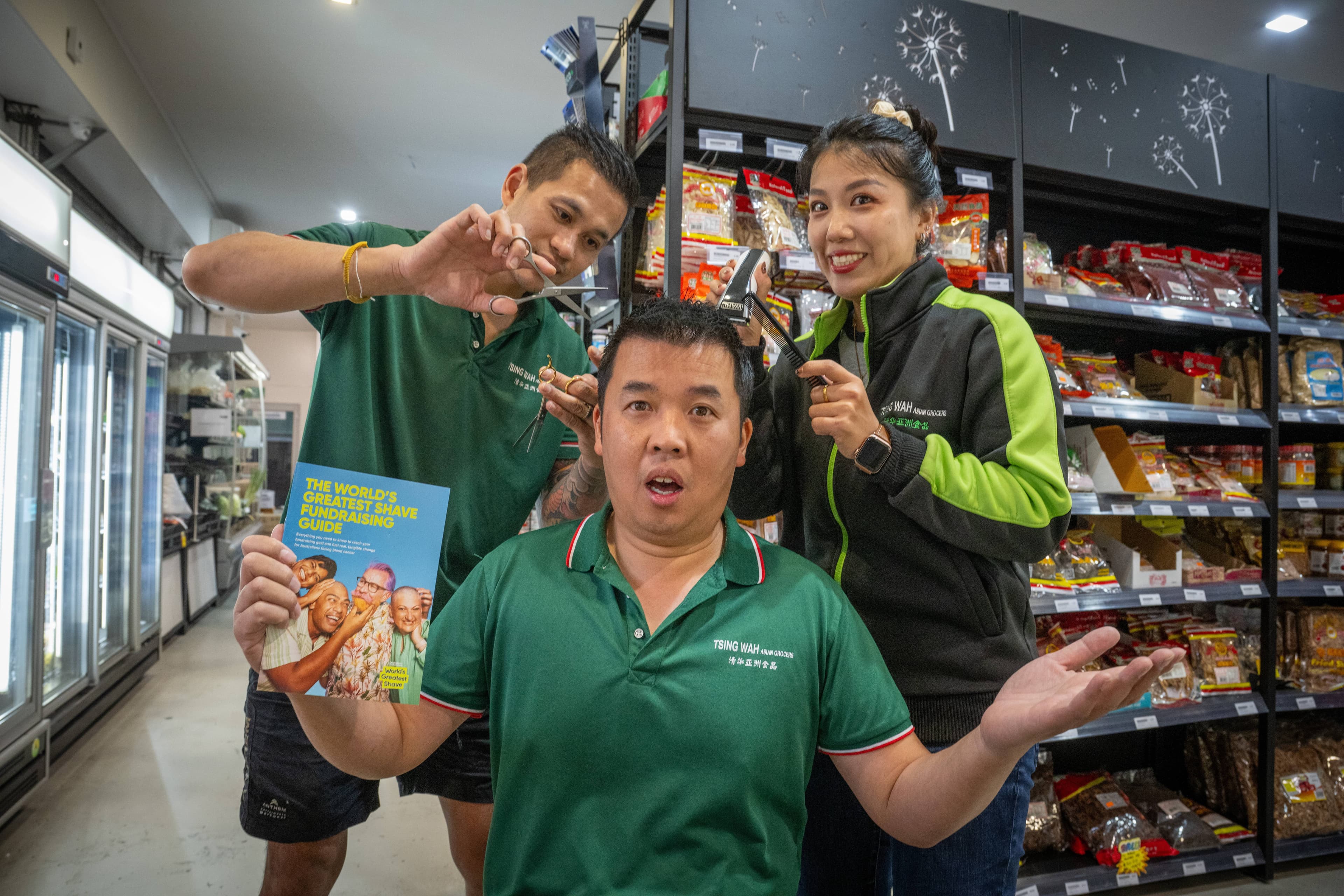 Anthony Kwong, owner of Tsing Wah Asian Grocers Launceston, before the world's greatest shave in March to raise money for blood cancers such as leukemia, with staff members Jem Suponok and Cindy He.