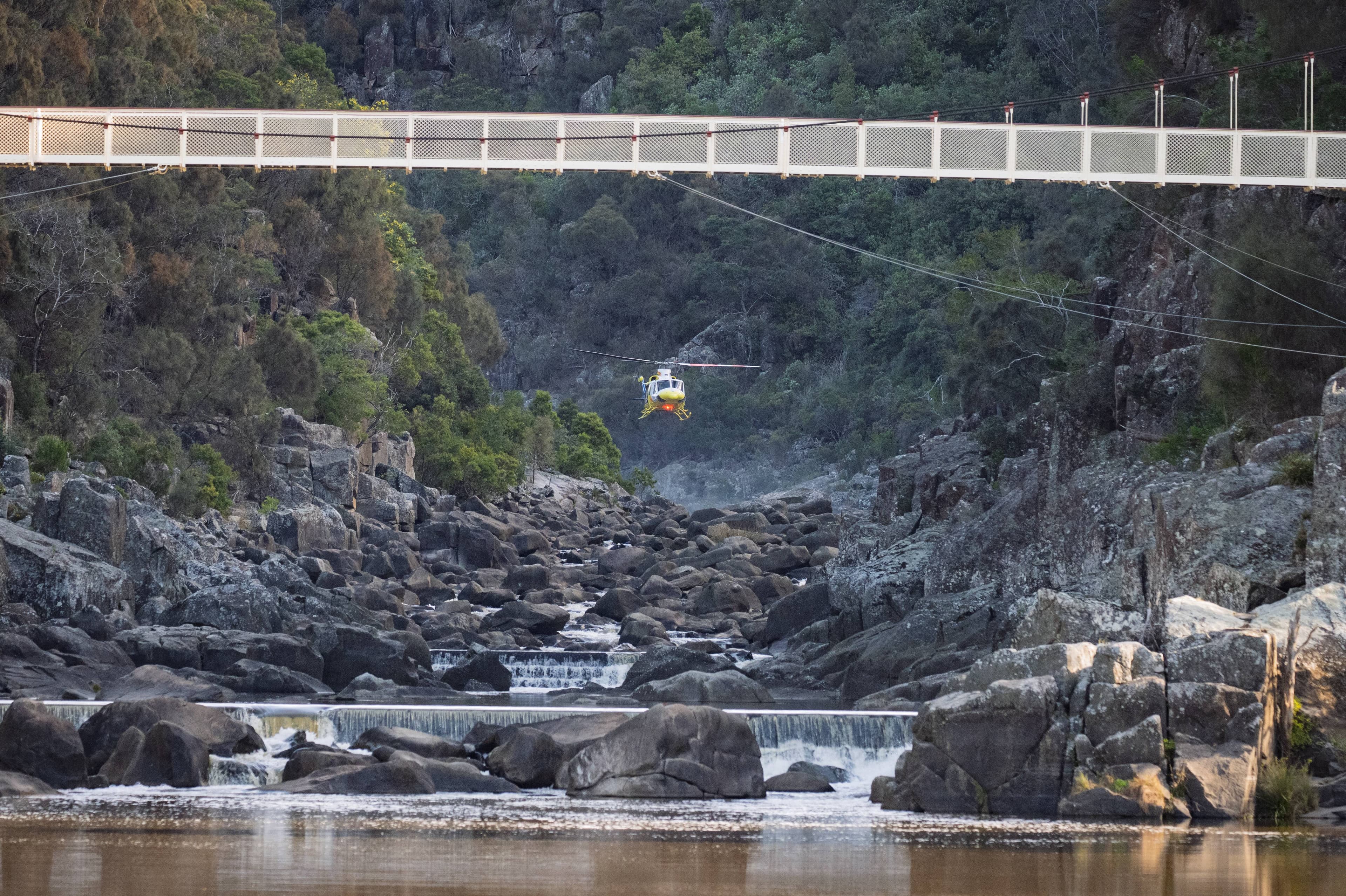 During a rescue the Air Ambulance arrives and hovers in the Cataract Gorge, behind the Alexandra Suspension Bridge, on September 1.