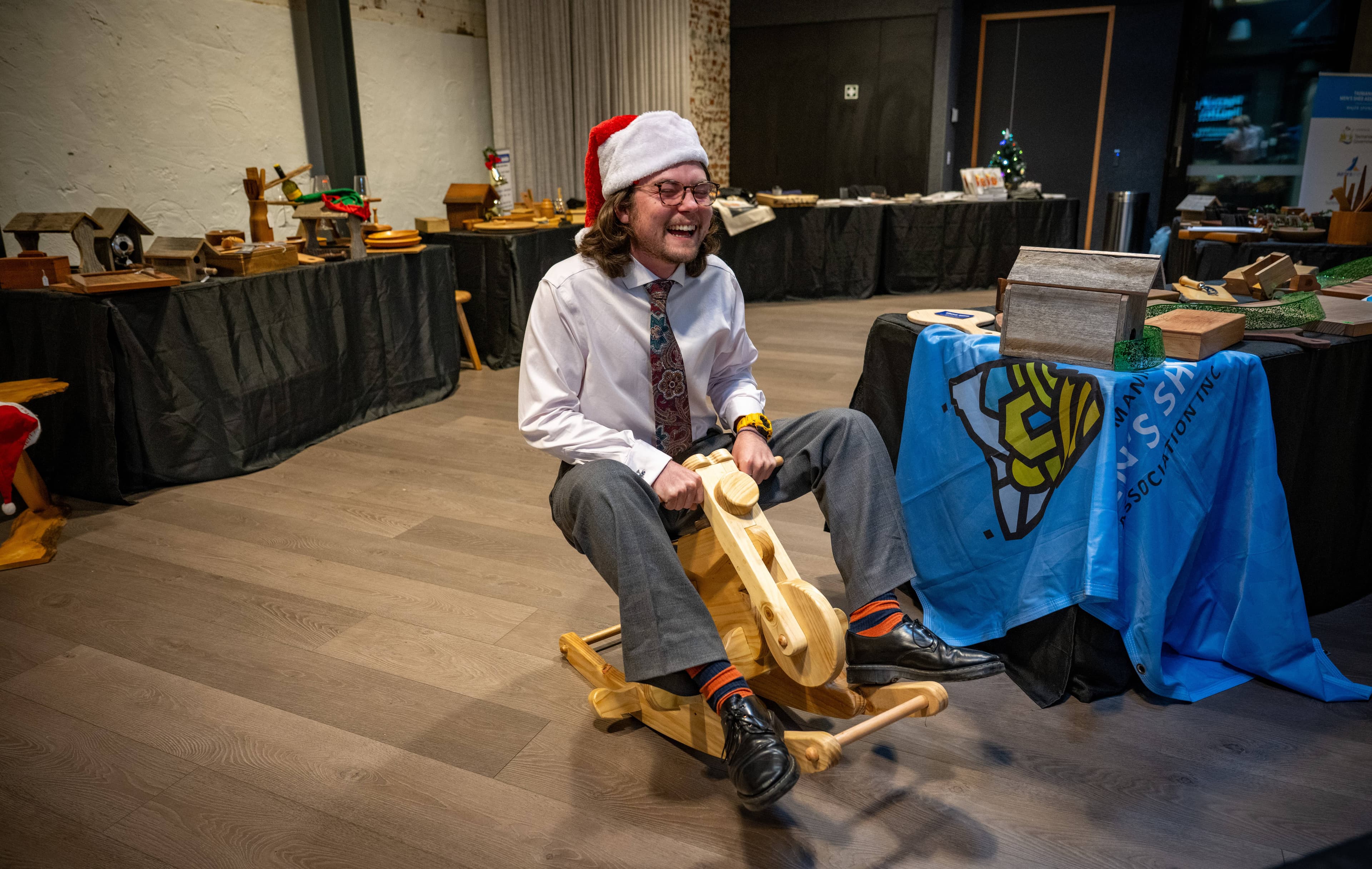 Examiner journalist Joe Colbrook was invited to test ride one of the rockers at the launch of the Tasmanian Men's Shed Association cookbook on International Men’s Day.
