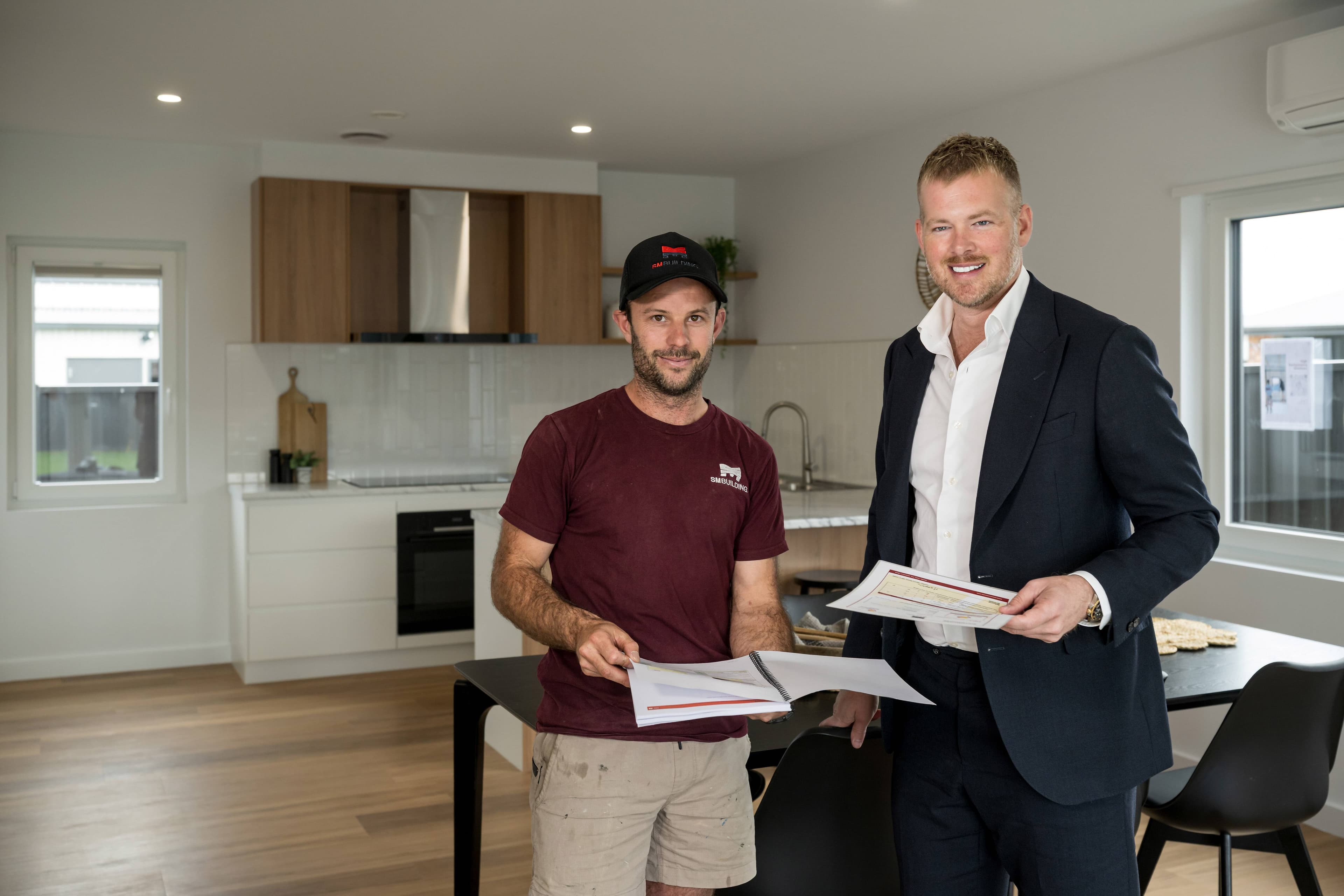 Builder Sam Mathew in the kitchen with property agent Josh Hart. Picture by Phillip Biggs