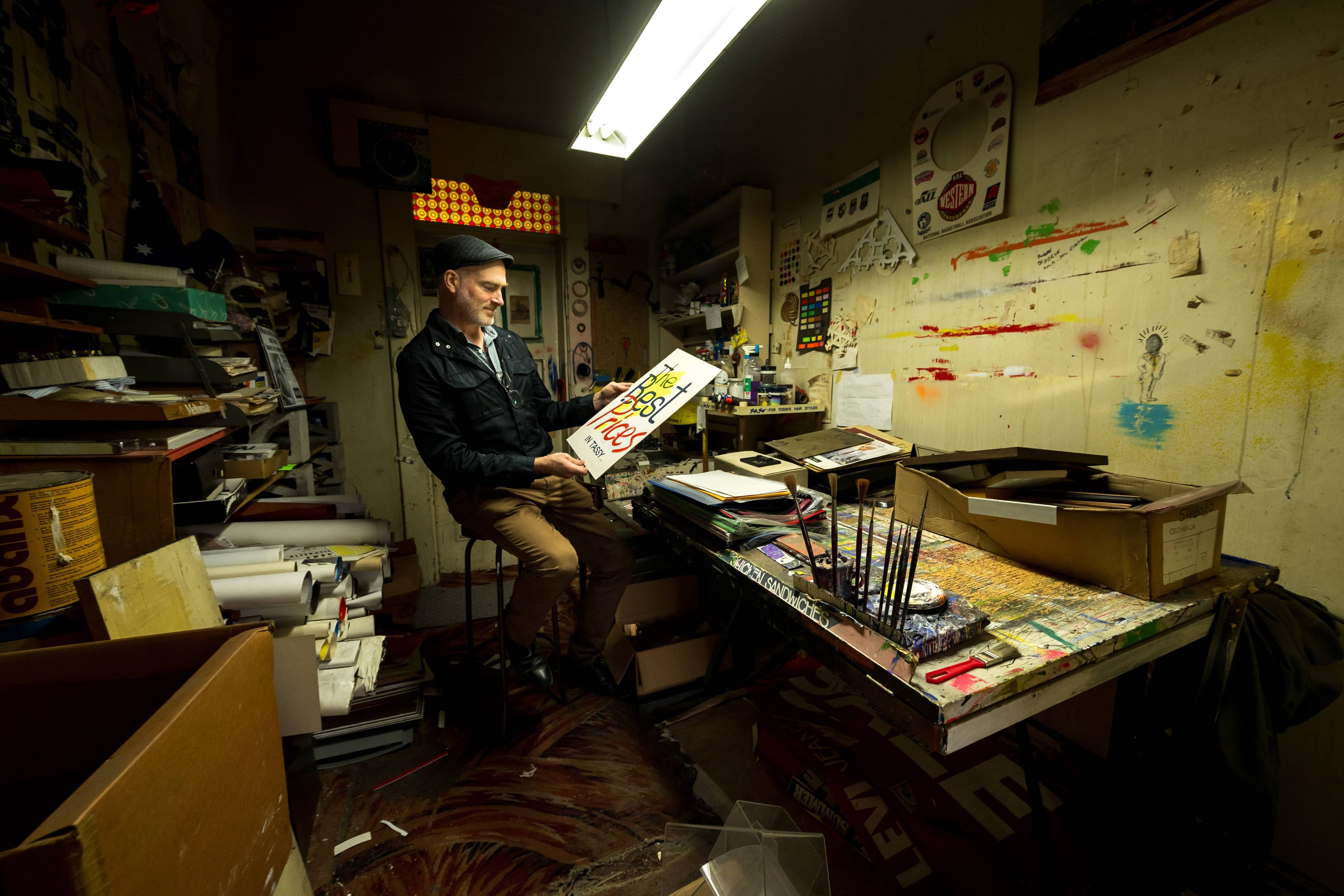 This picture shows Andrew Pitt in a small studio used for hand-painting signs at Neil Pitt's Menswear, in the old Majestic Theatre building.