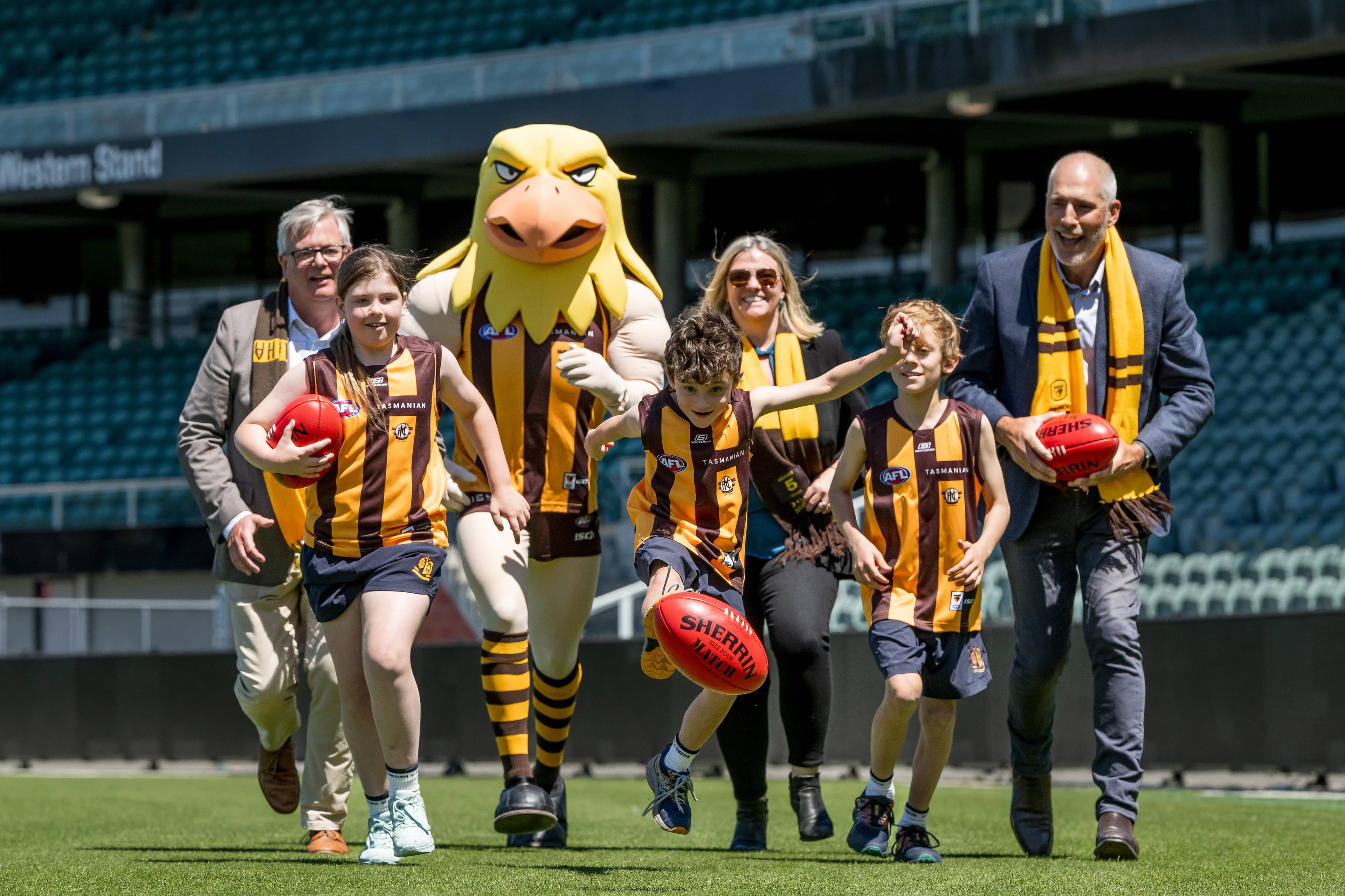 Minister for Sports and Events, Nick Duigan, announced a new deal with the Hawthorn Football Club to play at UTAS Stadium. Liberal Member for Bass Simon Wood, Independent Member for Bass Rebekah Pentland, Minister for Sports and Events Nick Duigan, with Eve Cox, Hawka, George Calvert and Percy Calvert on Monday, February 10 at the stadium.