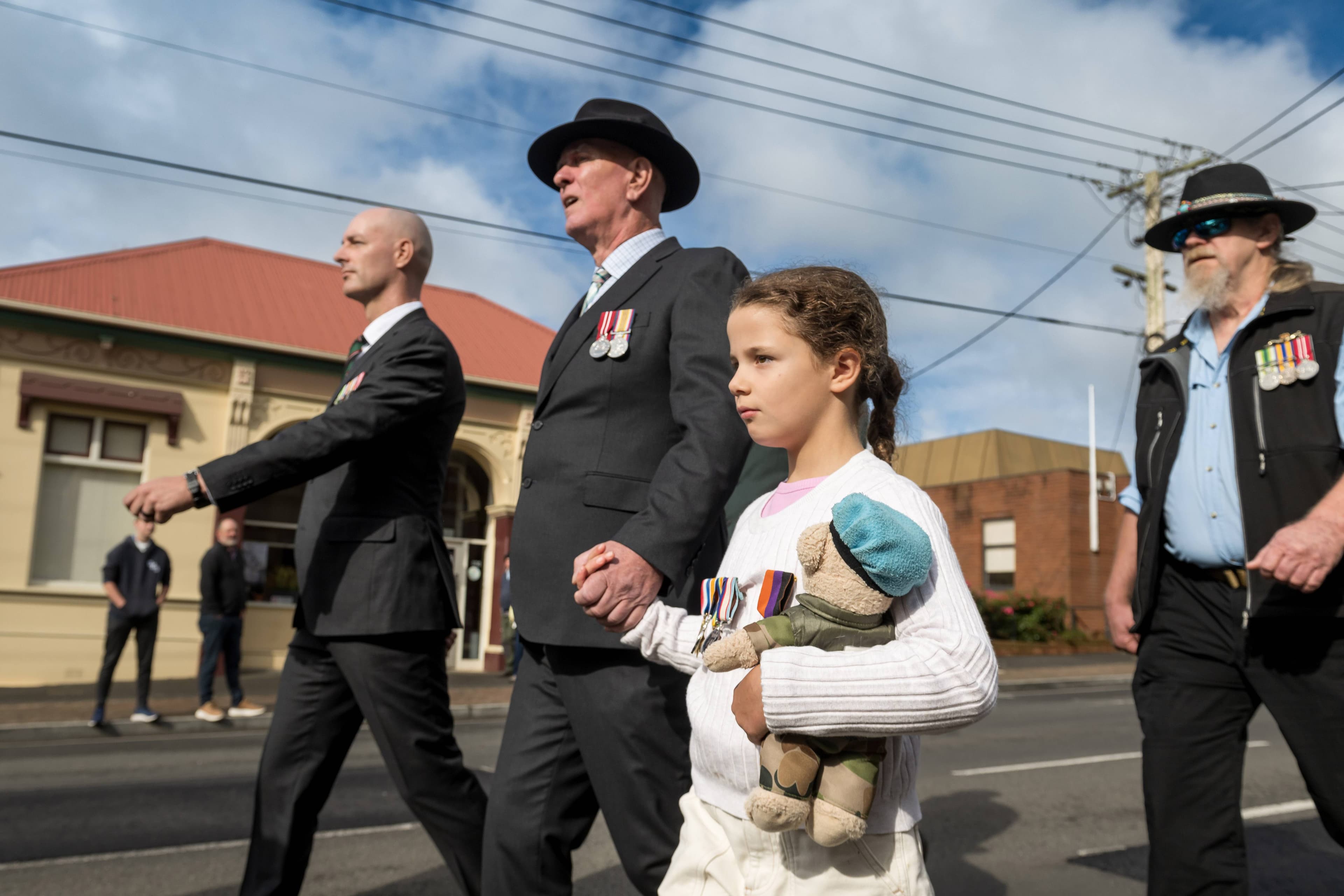 Three generations - James, David and Matilda Hill - march in the Deloraine Anzac march on Emu Bay Road, Deloraine.