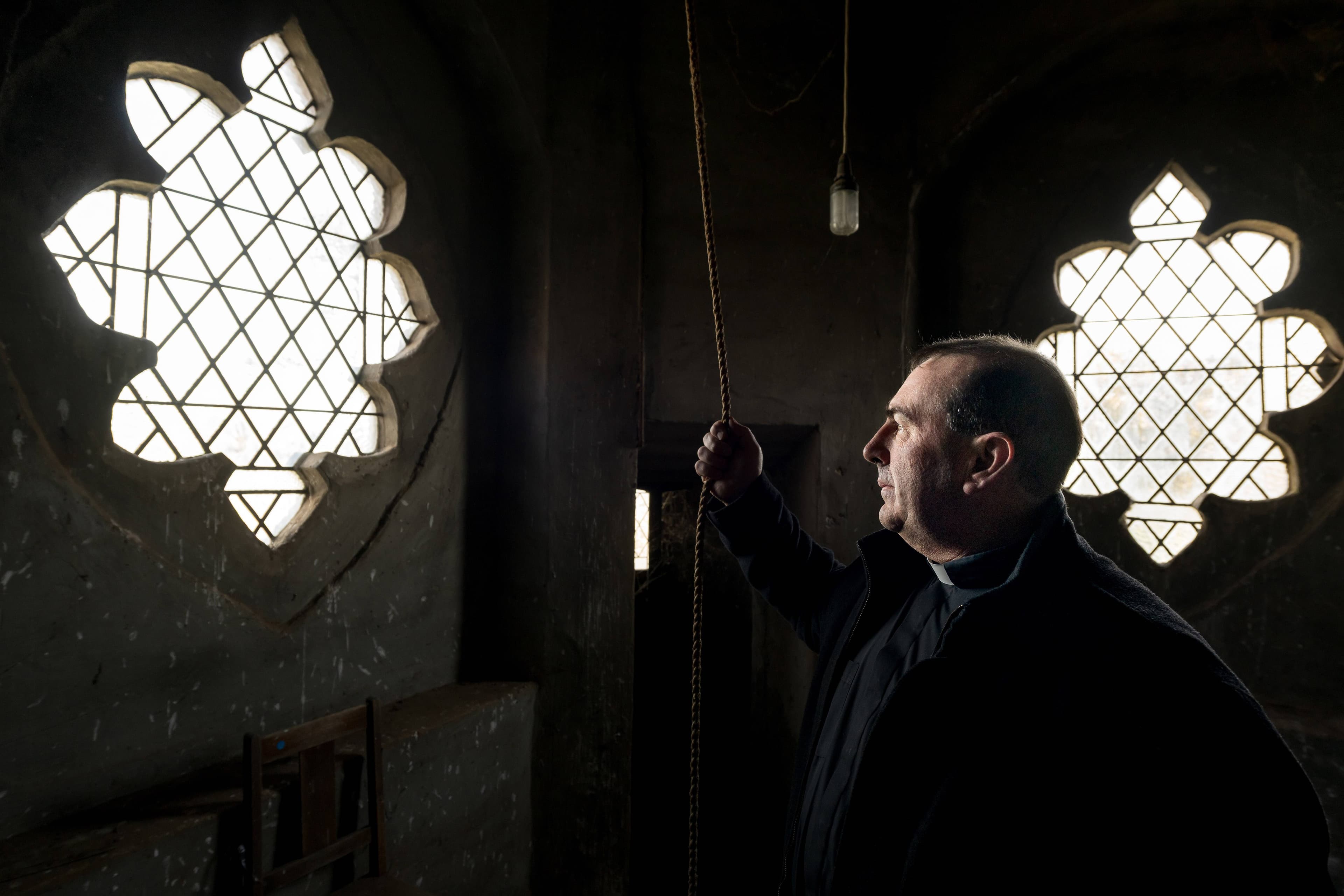 Reverend Paul Hobby with the rope to the bell in the bell tower at St Mary's Anglican Church at Hagley.